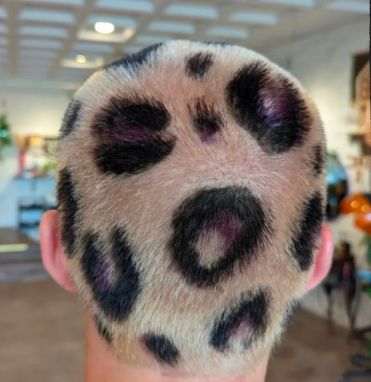Buzzed head with a leopard-print pattern dyed into the hair