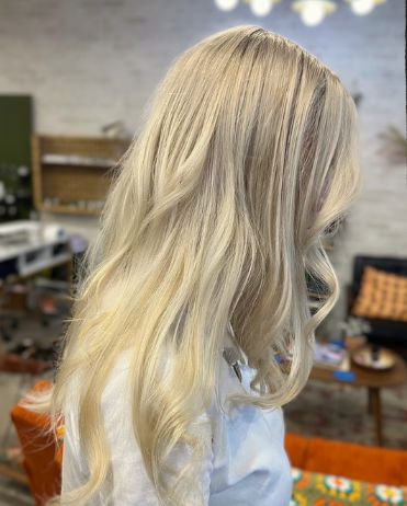 Client with long, bright blonde waves seen from behind