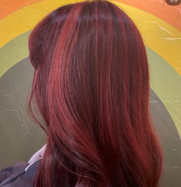 Client with long, vivid red hair seen from behind