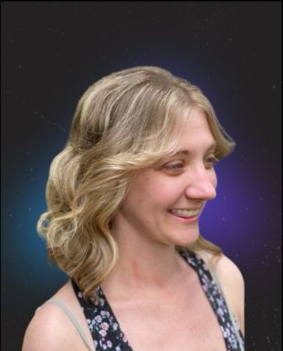 Smiling client with a blonde shoulder-length layered cut