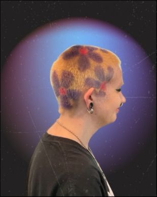 Client with a buzzed cut dyed with a colorful pattern, in profile